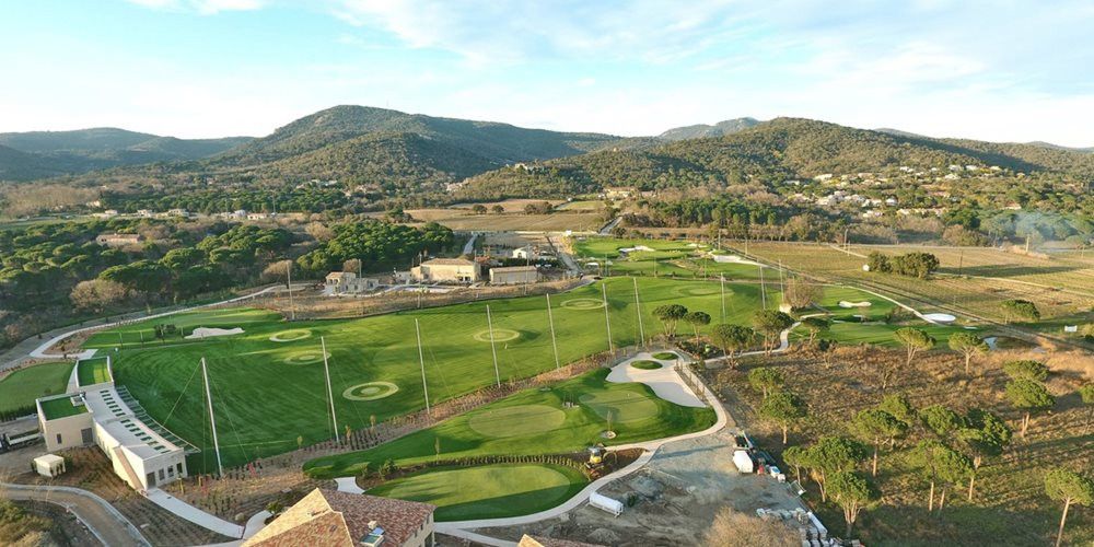 Los Angeles and Southern California Aerial view of a synthetic grass golf course surrounded by hills